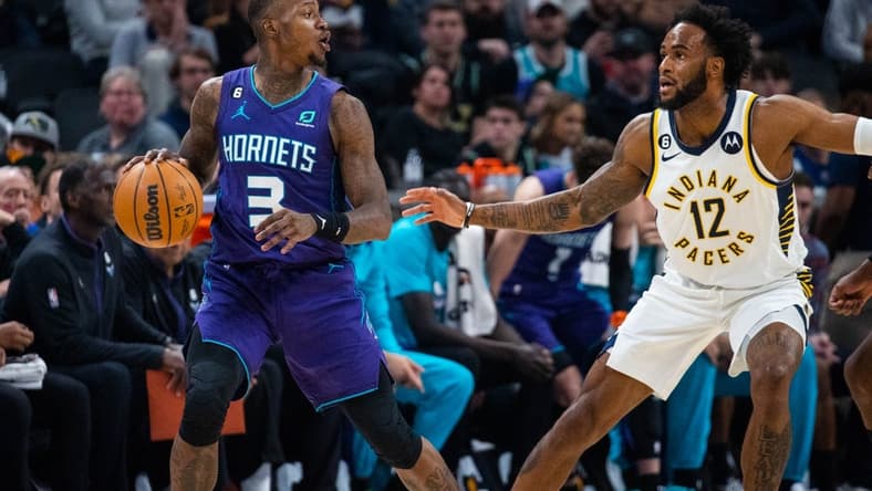 Jan 8, 2023; Indianapolis, Indiana, USA; Charlotte Hornets guard Terry Rozier (3) dribbles the ball while Indiana Pacers forward Oshae Brissett (12) defends in the second quarter at Gainbridge Fieldhouse. Mandatory Credit: Trevor Ruszkowski-USA TODAY Sports