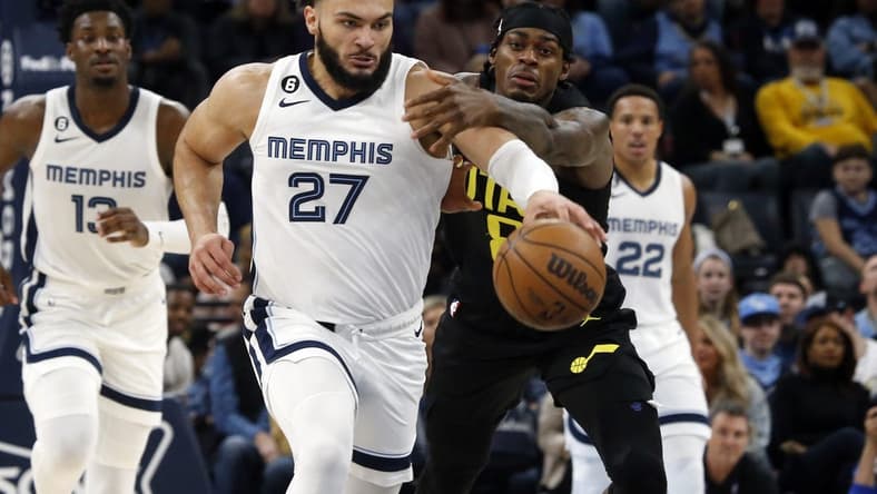 Jan 8, 2023; Memphis, Tennessee, USA; Memphis Grizzlies forward David Roddy (27) drives up the court as Utah Jazz forward Jarred Vanderbilt (8) defends during the first half at FedExForum. Mandatory Credit: Petre Thomas-USA TODAY Sports