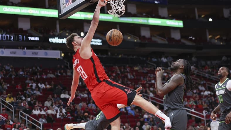 Jan 8, 2023; Houston, Texas, USA; Houston Rockets center Alperen Sengun (28) dunks the ball as Minnesota Timberwolves forward Taurean Prince (12) defends during the second quarter at Toyota Center. Mandatory Credit: Troy Taormina-USA TODAY Sports