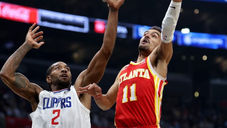 Jan 8, 2023; Los Angeles, California, USA; Atlanta Hawks guard Trae Young (11) shoots the ball against Los Angeles Clippers forward Kawhi Leonard (2) during the second quarter at Crypto.com Arena. Mandatory Credit: Kiyoshi Mio-USA TODAY Sports