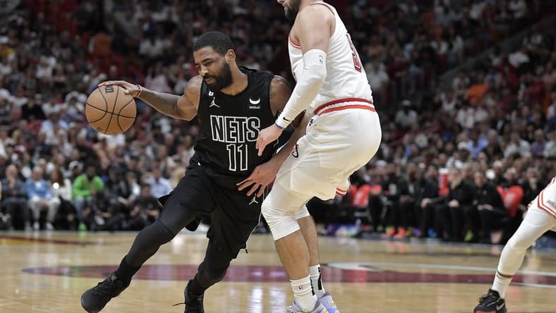 Jan 8, 2023; Miami, Florida, USA;  Brooklyn Nets guard Kyrie Irving (11) bumps into Miami Heat guard Max Strus (31) during the fourth quarter at FTX Arena. Mandatory Credit: Michael Laughlin-USA TODAY Sports