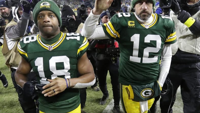 Jan 8, 2023; Green Bay, Wisconsin, USA; Green Bay Packers wide receiver Randall Cobb (18) and quarterback Aaron Rodgers (12) leave the field together after losing to the Detroit Lions at Lambeau Field. Mandatory Credit: Dan Powers/Appleton Post-Crescent via USA TODAY NETWORK