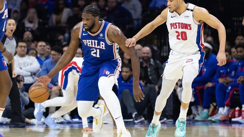 Jan 10, 2023; Philadelphia, Pennsylvania, USA; Philadelphia 76ers center Joel Embiid (21) dribbles up court in front of Detroit Pistons forward Kevin Knox II (20) during the first quarter at Wells Fargo Center. Mandatory Credit: Bill Streicher-USA TODAY Sports