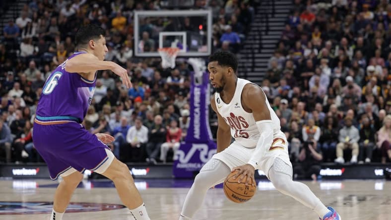 Jan 10, 2023; Salt Lake City, Utah, USA; Cleveland Cavaliers guard Donovan Mitchell (45) keeps the ball from Utah Jazz forward Simone Fontecchio (16) during the second quarter at Vivint Arena. Mandatory Credit: Chris Nicoll-USA TODAY Sports