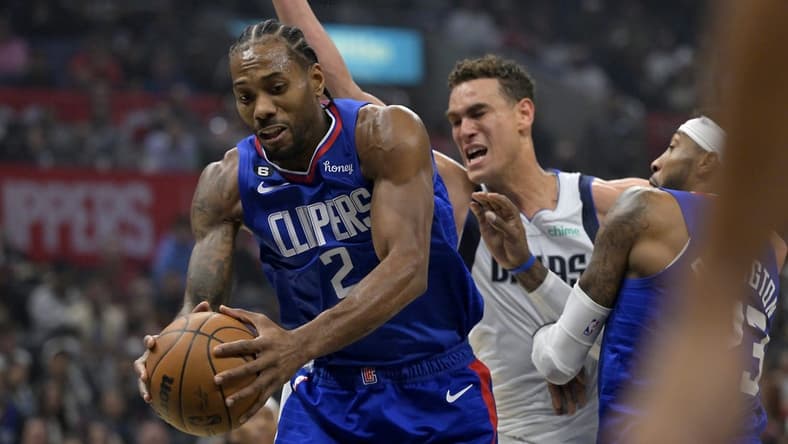 Jan 10, 2023; Los Angeles, California, USA; Los Angeles Clippers forward Kawhi Leonard (2) reaches in front of Dallas Mavericks center Dwight Powell (7) for a rebound in the first half at Crypto.com Arena. Mandatory Credit: Jayne Kamin-Oncea-USA TODAY Sports
