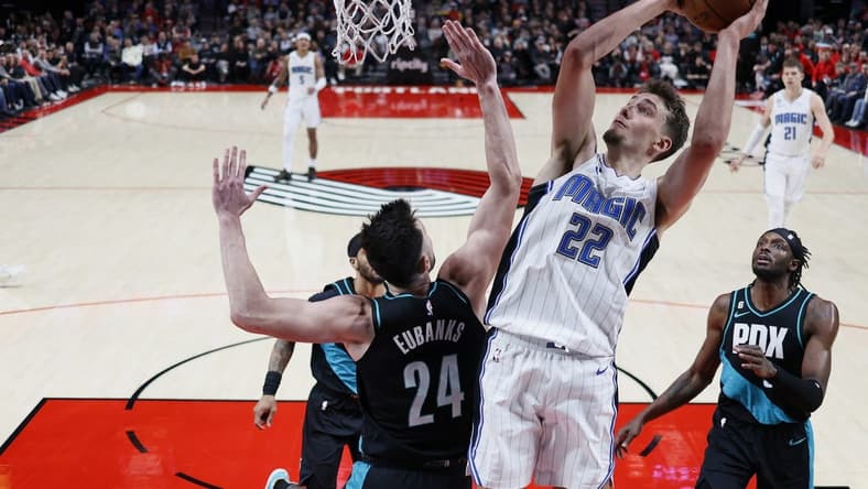 Jan 10, 2023; Portland, Oregon, USA; ]Orlando Magic small forward Franz Wagner (22) shoots the ball against Portland Trail Blazers power forward Drew Eubanks (24) during the first half at Moda Center. Mandatory Credit: Soobum Im-USA TODAY Sports
