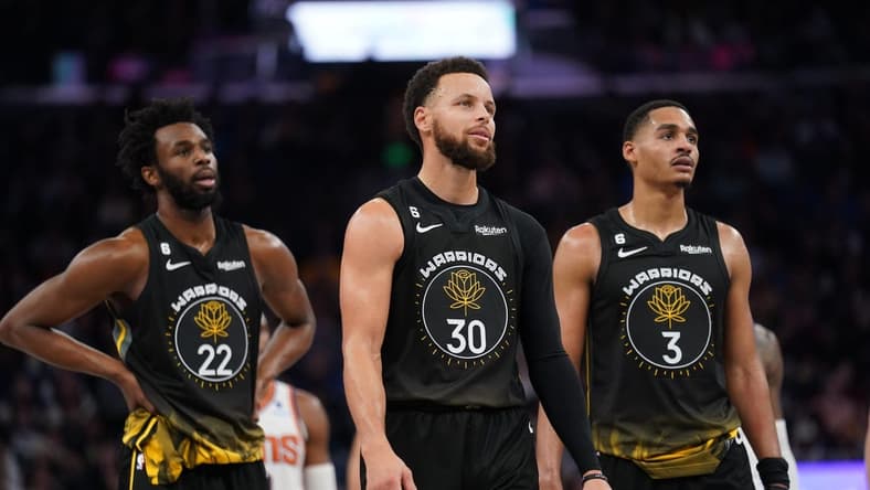 Jan 10, 2023; San Francisco, California, USA; Golden State Warriors guard Stephen Curry (30) stands next to forward Andrew Wiggins (22) and guard Jordan Poole (3) after a foul was called against the Warriors during action against the Phoenix Suns in the fourth quarter at the Chase Center. Mandatory Credit: Cary Edmondson-USA TODAY Sports