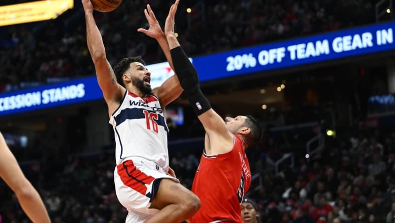 Jan 11, 2023; Washington, District of Columbia, USA; Washington Wizards forward Anthony Gill (16) shoots over Chicago Bulls center Nikola Vucevic (9) during the first half at Capital One Arena. Mandatory Credit: Brad Mills-USA TODAY Sports
