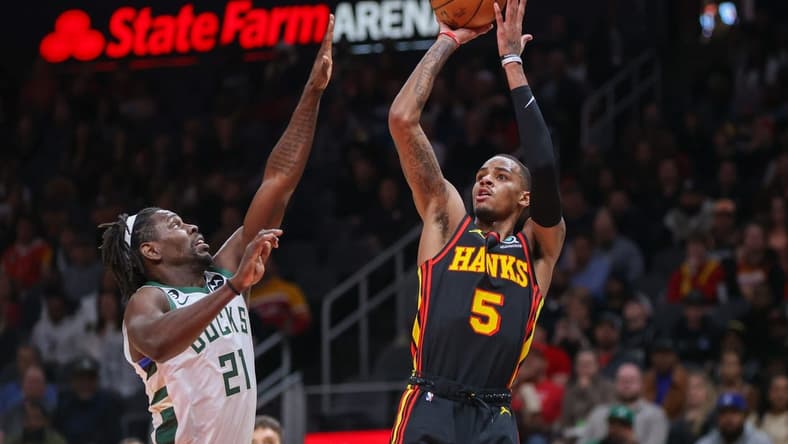 Jan 11, 2023; Atlanta, Georgia, USA; Atlanta Hawks guard Dejounte Murray (5) shoots over Milwaukee Bucks guard Jrue Holiday (21) in the first quarter at State Farm Arena. Mandatory Credit: Brett Davis-USA TODAY Sports