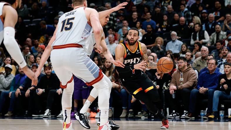 Jan 11, 2023; Denver, Colorado, USA; Phoenix Suns guard Duane Washington Jr. (4) controls the ball under pressure from Denver Nuggets forward Michael Porter Jr. (1) and center Nikola Jokic (15) in the first quarter at Ball Arena. Mandatory Credit: Isaiah J. Downing-USA TODAY Sports