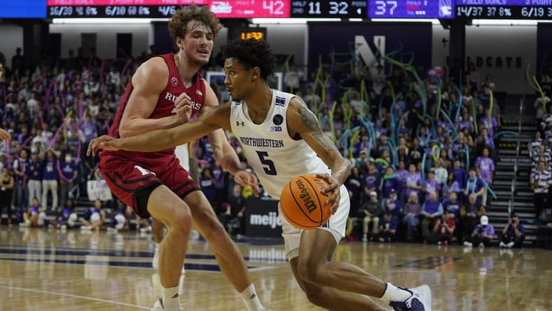 Jan 11, 2023; Evanston, Illinois, USA; Rutgers Scarlet Knights forward Dean Reiber (21) defends Northwestern Wildcats guard Julian Roper II (5) during the second half at Welsh-Ryan Arena. Mandatory Credit: David Banks-USA TODAY Sports