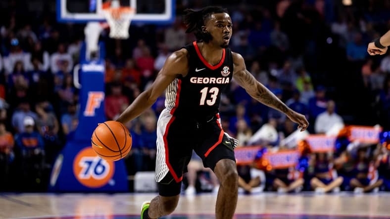 Jan 7, 2023; Gainesville, Florida, USA; Georgia Bulldogs guard Mardrez McBride (13) dribbles the ball during the first half against the Florida Gators at Exactech Arena at the Stephen C. O'Connell Center. Mandatory Credit: Matt Pendleton-USA TODAY Sports