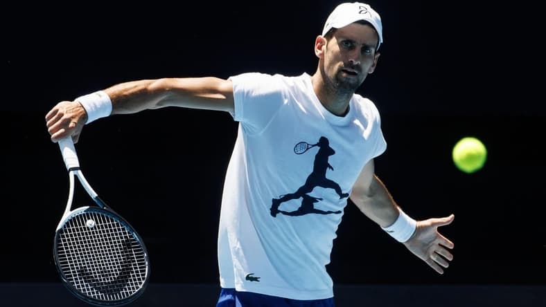 Jan 12, 2023; Melbourne, Victoria, Australia; Novak Djokovic of Serbia hits a backhand during a practice session on Rod Laver Arena with his coach Goran Ivanisevic at Melbourne Park. Mandatory Credit: Mike Frey-USA TODAY Sports