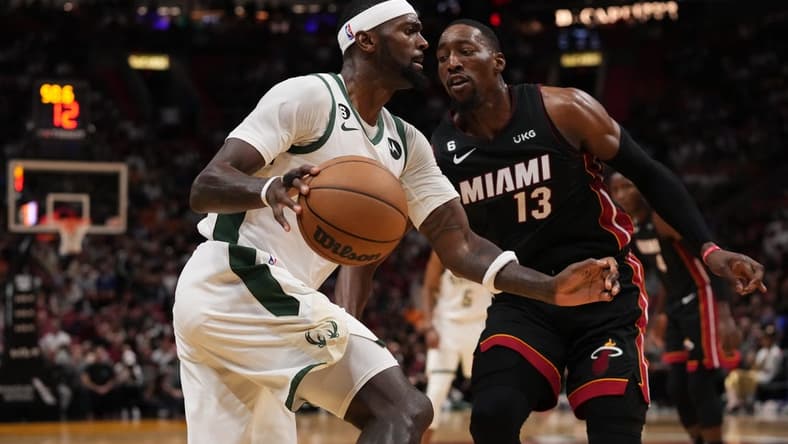 Jan 12, 2023; Miami, Florida, USA; Milwaukee Bucks forward Bobby Portis (9) dribbles against Miami Heat center Bam Adebayo (13) at The Arena. Mandatory Credit: Jasen Vinlove-USA TODAY Sports