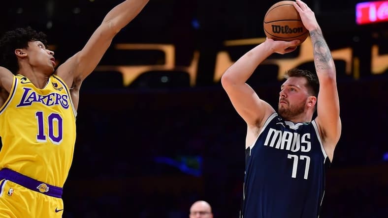 Jan 12, 2023; Los Angeles, California, USA; Dallas Mavericks guard Luka Doncic (77) shoots against Los Angeles Lakers guard Max Christie (10) during the first half at Crypto.com Arena. Mandatory Credit: Gary A. Vasquez-USA TODAY Sports