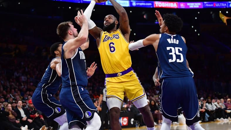 Jan 12, 2023; Los Angeles, California, USA; Los Angeles Lakers forward LeBron James (6) moves to the basket against Dallas Mavericks guard Luka Doncic (77) and forward Christian Wood (35) during the second half at Crypto.com Arena. Mandatory Credit: Gary A. Vasquez-USA TODAY Sports
