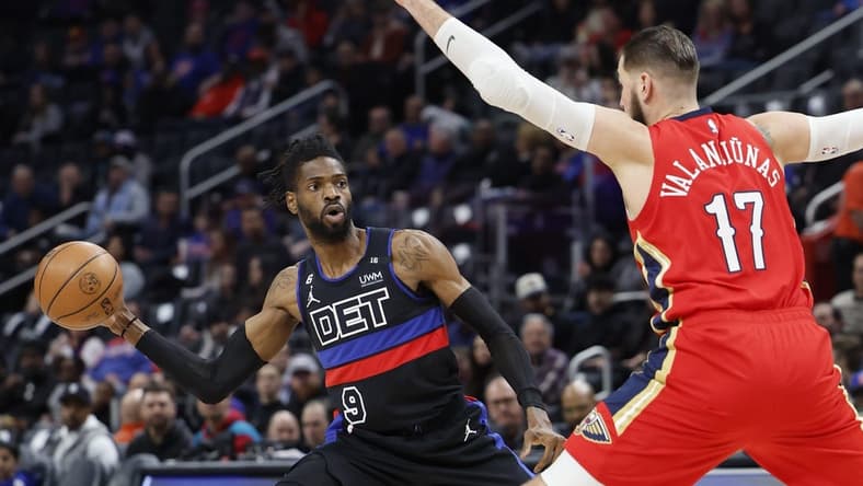 Jan 13, 2023; Detroit, Michigan, USA; Detroit Pistons guard Nerlens Noel (9) passes defended by New Orleans Pelicans center Jonas Valanciunas (17) in the first half at Little Caesars Arena. Mandatory Credit: Rick Osentoski-USA TODAY Sports