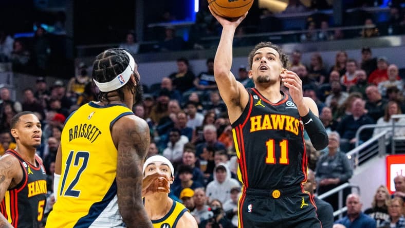 Jan 13, 2023; Indianapolis, Indiana, USA; Atlanta Hawks guard Trae Young (11) shoots the ball while Indiana Pacers forward Oshae Brissett (12) defends in the second quarter at Gainbridge Fieldhouse. Mandatory Credit: Trevor Ruszkowski-USA TODAY Sports