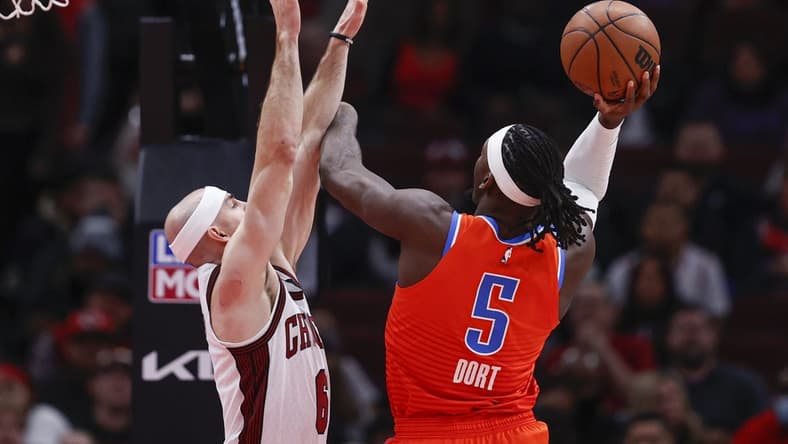 Jan 13, 2023; Chicago, Illinois, USA; Oklahoma City Thunder guard Luguentz Dort (5) goes to the basket against Chicago Bulls guard Alex Caruso (6) during the first half at United Center. Mandatory Credit: Kamil Krzaczynski-USA TODAY Sports