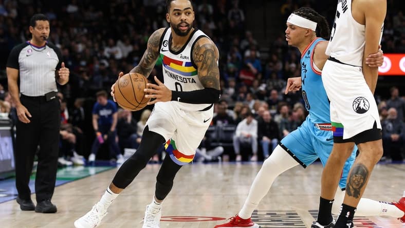 Jan 13, 2023; Minneapolis, Minnesota, USA; Minnesota Timberwolves guard D'Angelo Russell (0) dribbles while Phoenix Suns guard Damion Lee (10) defends during the second quarter at Target Center. Mandatory Credit: Matt Krohn-USA TODAY Sports