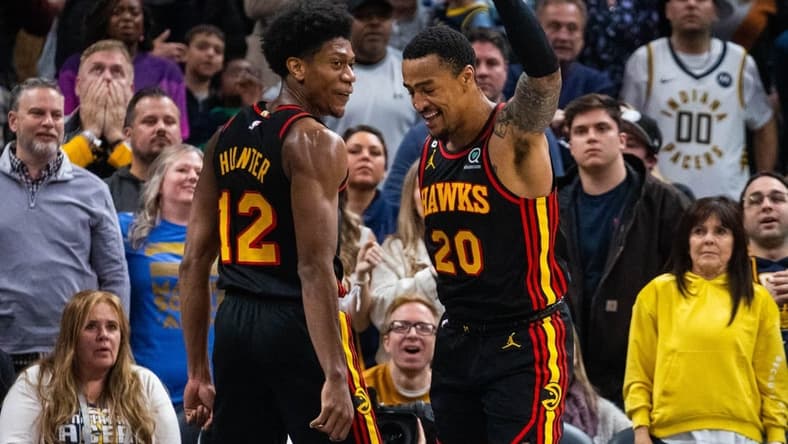 Jan 13, 2023; Indianapolis, Indiana, USA; Atlanta Hawks forward John Collins (20) celebrates his game-winning shot with forward De'Andre Hunter (12) in the second half against the Indiana Pacers at Gainbridge Fieldhouse. Mandatory Credit: Trevor Ruszkowski-USA TODAY Sports