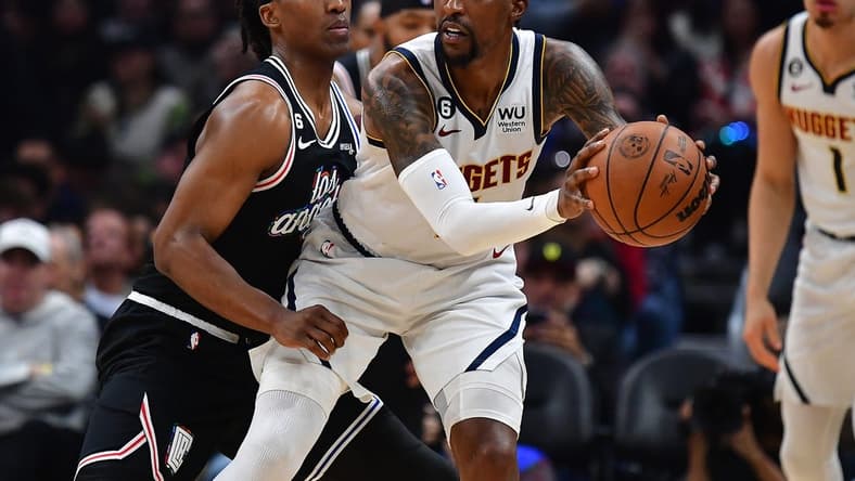 January 13, 2023; Los Angeles, California, USA; Denver Nuggets guard Kentavious Caldwell-Pope (5) moves the ball against Los Angeles Clippers guard Terance Mann (14) during the first half at Crypto.com Arena. Mandatory Credit: Gary A. Vasquez-USA TODAY Sports