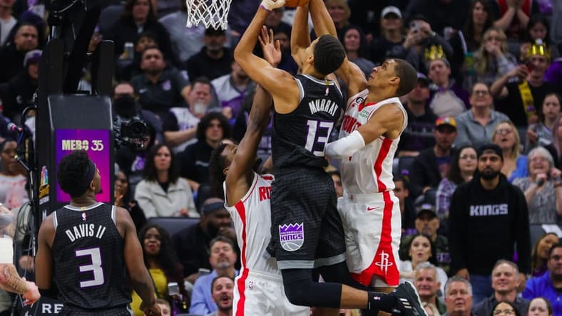 Jan 13, 2023; Sacramento, California, USA; Sacramento Kings forward Keegan Murray (13) is guarded by Houston Rockets forward Jabari Smith Jr. (1) and forward Jae'Sean Tate (8) during the second quarter at Golden 1 Center. Mandatory Credit: Sergio Estrada-USA TODAY Sports