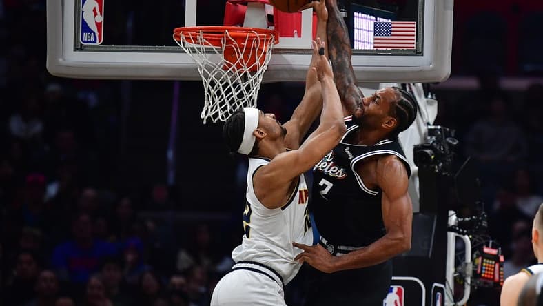 January 13, 2023; Los Angeles, California, USA; Los Angeles Clippers forward Kawhi Leonard (2) dunks against Denver Nuggets forward Zeke Nnaji (22) during the second half at Crypto.com Arena. Mandatory Credit: Gary A. Vasquez-USA TODAY Sports