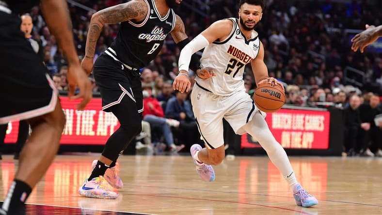 January 13, 2023; Los Angeles, California, USA; Denver Nuggets guard Jamal Murray (27) moves the ball against Los Angeles Clippers forward Marcus Morris Sr. (8) during the second half at Crypto.com Arena. Mandatory Credit: Gary A. Vasquez-USA TODAY Sports