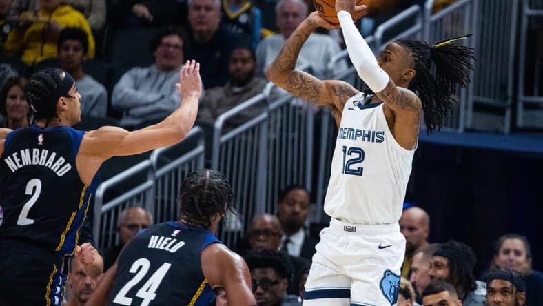 Jan 14, 2023; Indianapolis, Indiana, USA; Memphis Grizzlies guard Ja Morant (12) shoots the ball while Indiana Pacers guard Andrew Nembhard (2) defends in the first quarter at Gainbridge Fieldhouse. Mandatory Credit: Trevor Ruszkowski-USA TODAY Sports