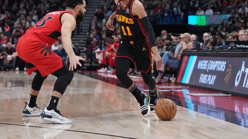 Jan 14, 2023; Toronto, Ontario, CAN; Atlanta Hawks guard Trae Young (11) controls the ball as Toronto Raptors guard Fred VanVleet (23) tries to defend during the first quarter at the Scotiabank Arena against the Toronto Raptors. Mandatory Credit: Nick Turchiaro-USA TODAY Sports