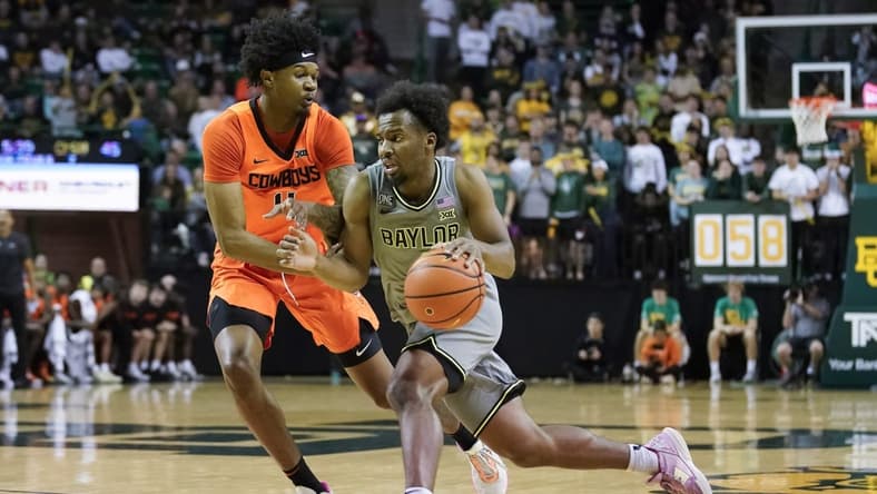 Jan 14, 2023; Waco, Texas, USA; Baylor Bears guard LJ Cryer (4) works past Oklahoma State Cowboys guard Woody Newton (4) during the second half at Ferrell Center. Mandatory Credit: Raymond Carlin III-USA TODAY Sports