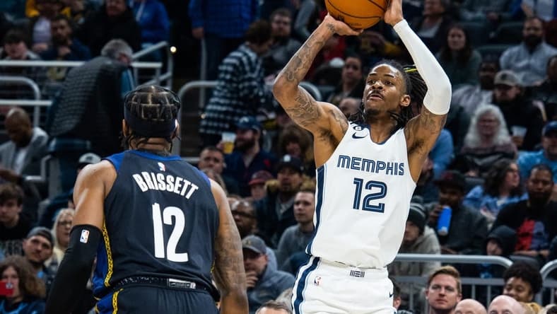 Jan 14, 2023; Indianapolis, Indiana, USA; Memphis Grizzlies guard Ja Morant (12) shoots the ball while Indiana Pacers forward Oshae Brissett (12) defends in the second half at Gainbridge Fieldhouse. Mandatory Credit: Trevor Ruszkowski-USA TODAY Sports