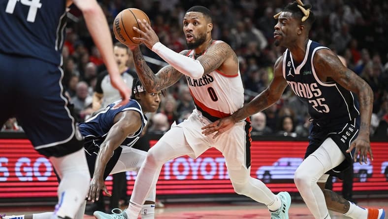 Jan 14, 2023; Portland, Oregon, USA; Portland Trail Blazers guard Damian Lillard (0) drives to the basket during the first half against Dallas Mavericks forward Reggie Bullock (25) at Moda Center. Mandatory Credit: Troy Wayrynen-USA TODAY Sports