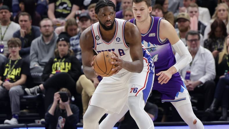 Jan 14, 2023; Salt Lake City, Utah, USA; Philadelphia 76ers center Joel Embiid (21) keeps the ball away from Utah Jazz center Walker Kessler (24) during the second half at Vivint Arena. Mandatory Credit: Chris Nicoll-USA TODAY Sports