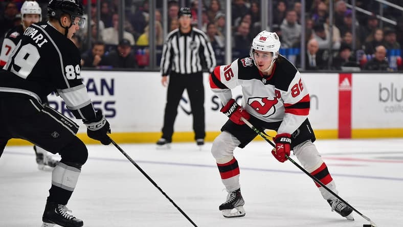 January 14, 2023; Los Angeles, California, USA; New Jersey Devils center Jack Hughes (86) moves the puck against Los Angeles Kings center Rasmus Kupari (89) during the third period at Crypto.com Arena. Mandatory Credit: Gary A. Vasquez-USA TODAY Sports