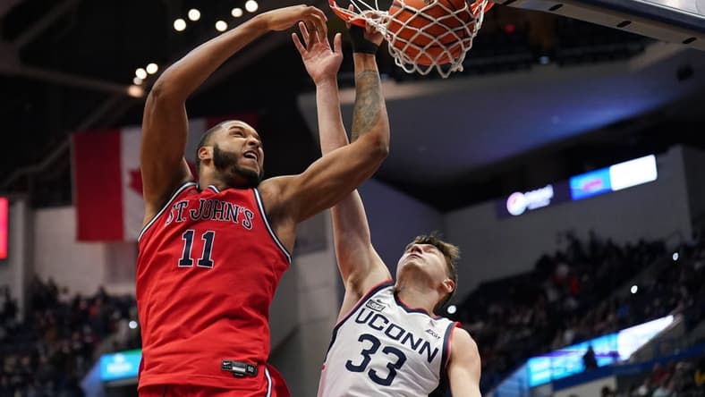 Jan 15, 2023; Hartford, Connecticut, USA; St. John's Red Storm center Joel Soriano (11) shoots against UConn Huskies guard Apostolos Roumoglou (33) in the second half at XL Center. Mandatory Credit: David Butler II-USA TODAY Sports