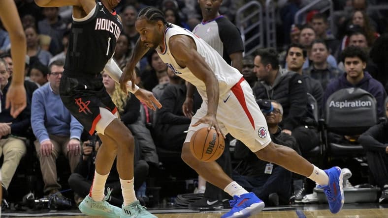 Jan 15, 2023; Los Angeles, California, USA; Los Angeles Clippers forward Kawhi Leonard (2) drives past Houston Rockets forward Jabari Smith Jr. (1) in the first half at Crypto.com Arena. Mandatory Credit: Jayne Kamin-Oncea-USA TODAY Sports