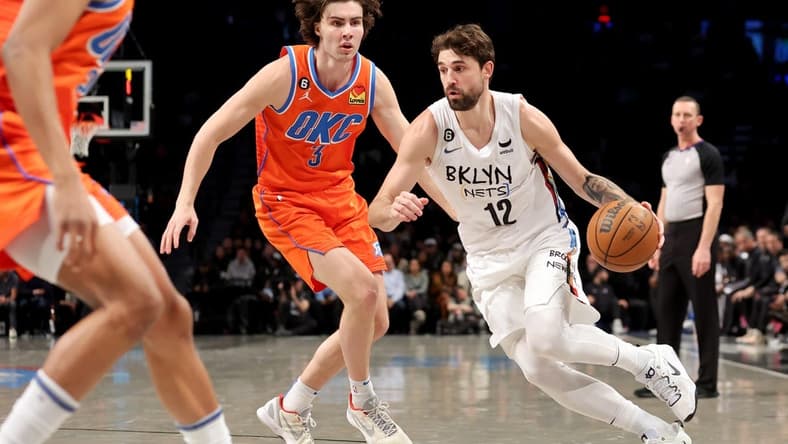 Jan 15, 2023; Brooklyn, New York, USA; Brooklyn Nets forward Joe Harris (12) drives to the basket against Oklahoma City Thunder guard Josh Giddey (3) during the second quarter at Barclays Center. Mandatory Credit: Brad Penner-USA TODAY Sports