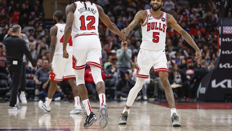 Jan 15, 2023; Chicago, Illinois, USA; Chicago Bulls guard Ayo Dosunmu (12) is congratulated by forward Derrick Jones Jr. (5) after scoring against the Golden State Warriors during the second half of an NBA game at United Center. Mandatory Credit: Kamil Krzaczynski-USA TODAY Sports