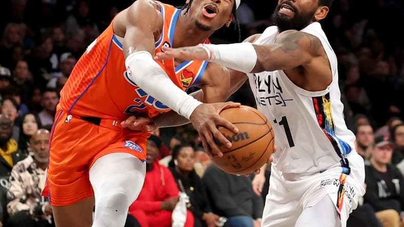 Jan 15, 2023; Brooklyn, New York, USA; Oklahoma City Thunder guard Shai Gilgeous-Alexander (2) is fouled as he drives to the basket by Brooklyn Nets guard Kyrie Irving (11) during the third quarter at Barclays Center. Mandatory Credit: Brad Penner-USA TODAY Sports