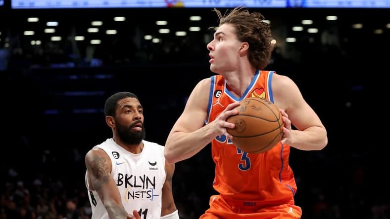 Jan 15, 2023; Brooklyn, New York, USA; Oklahoma City Thunder guard Josh Giddey (3) drives to the basket against Brooklyn Nets guard Kyrie Irving (11) during the fourth quarter at Barclays Center. Mandatory Credit: Brad Penner-USA TODAY Sports