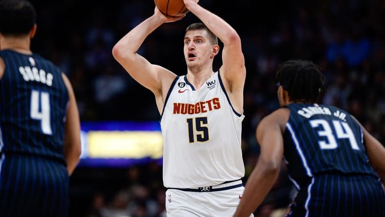 Jan 15, 2023; Denver, Colorado, USA; Denver Nuggets center Nikola Jokic (15) controls the ball against Orlando Magic center Wendell Carter Jr. (34) and guard Jalen Suggs (4) in the first quarter at Ball Arena. Mandatory Credit: Isaiah J. Downing-USA TODAY Sports
