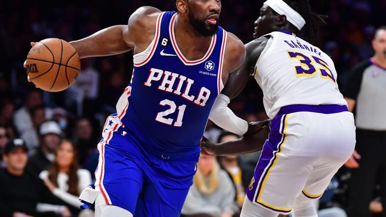 Jan 15, 2023; Los Angeles, California, USA; Philadelphia 76ers center Joel Embiid (21) moves the ball against Los Angeles Lakers forward Wenyen Gabriel (35) during the first half at Crypto.com Arena. Mandatory Credit: Gary A. Vasquez-USA TODAY Sports