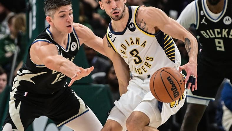 Jan 16, 2023; Milwaukee, Wisconsin, USA; Milwaukee Bucks guard Grayson Allen (12) tries to steal ball from Indiana Pacers guard Chris Duarte (3) in the second quarter at Fiserv Forum. Mandatory Credit: Benny Sieu-USA TODAY Sports