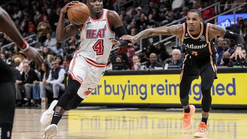 Jan 16, 2023; Atlanta, Georgia, USA; Miami Heat guard Victor Oladipo (4) drives to the basket defended by Atlanta Hawks guard Dejounte Murray (5) during the first half at State Farm Arena. Mandatory Credit: Dale Zanine-USA TODAY Sports
