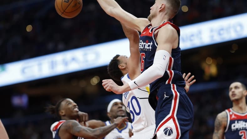 Jan 16, 2023; Washington, District of Columbia, USA; Washington Wizards center Kristaps Porzingis (6) blocks the shot of Golden State Warriors guard Stephen Curry (30) in the first quarter at Capital One Arena. Mandatory Credit: Geoff Burke-USA TODAY Sports