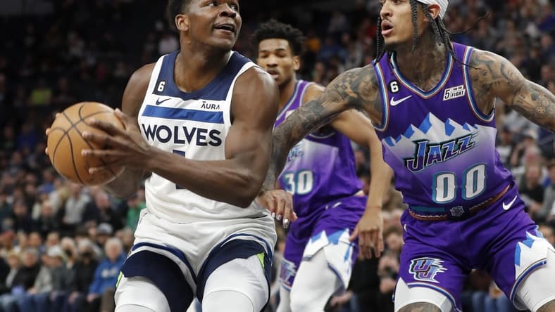 Jan 16, 2023; Minneapolis, Minnesota, USA; Minnesota Timberwolves forward Anthony Edwards (1) works against Utah Jazz guard Jordan Clarkson (00) in the first quarter at Target Center. Mandatory Credit: Bruce Kluckhohn-USA TODAY Sports