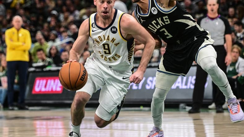 Jan 16, 2023; Milwaukee, Wisconsin, USA; Indiana Pacers guard T.J. McConnell (9) drives for the basket against Milwaukee Bucks guard George Hill (3) in the third quarter at Fiserv Forum. Mandatory Credit: Benny Sieu-USA TODAY Sports