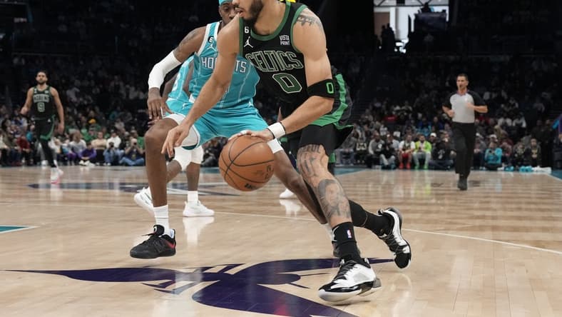 Jan 16, 2023; Charlotte, North Carolina, USA; Boston Celtics forward Jayson Tatum (0) drives to the basket guarded by Charlotte Hornets forward Jalen McDaniels (6) during the first quarter at Spectrum Center. Mandatory Credit: Jim Dedmon-USA TODAY Sports